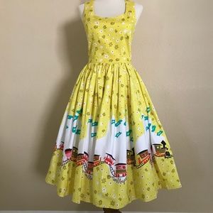 Pinup Girl Clothing Aurora Dress in Mary Blair Yellow Train Print